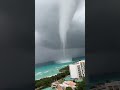 Waterspout Towers Over Shore