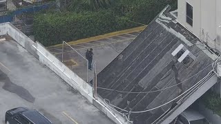 Two cars trapped underneath partially collapsed walkway in Hallandale Beach