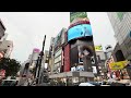 Shibuya Crossing and a plane above