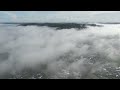 Drone flying up above fog in small town Latrobe Tasmania