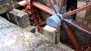 Historical low shot waterwheel running under flood conditions