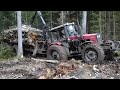 Belarus Mtz 1221.2 forestry tractor with large fully loaded trailer stuck in mud