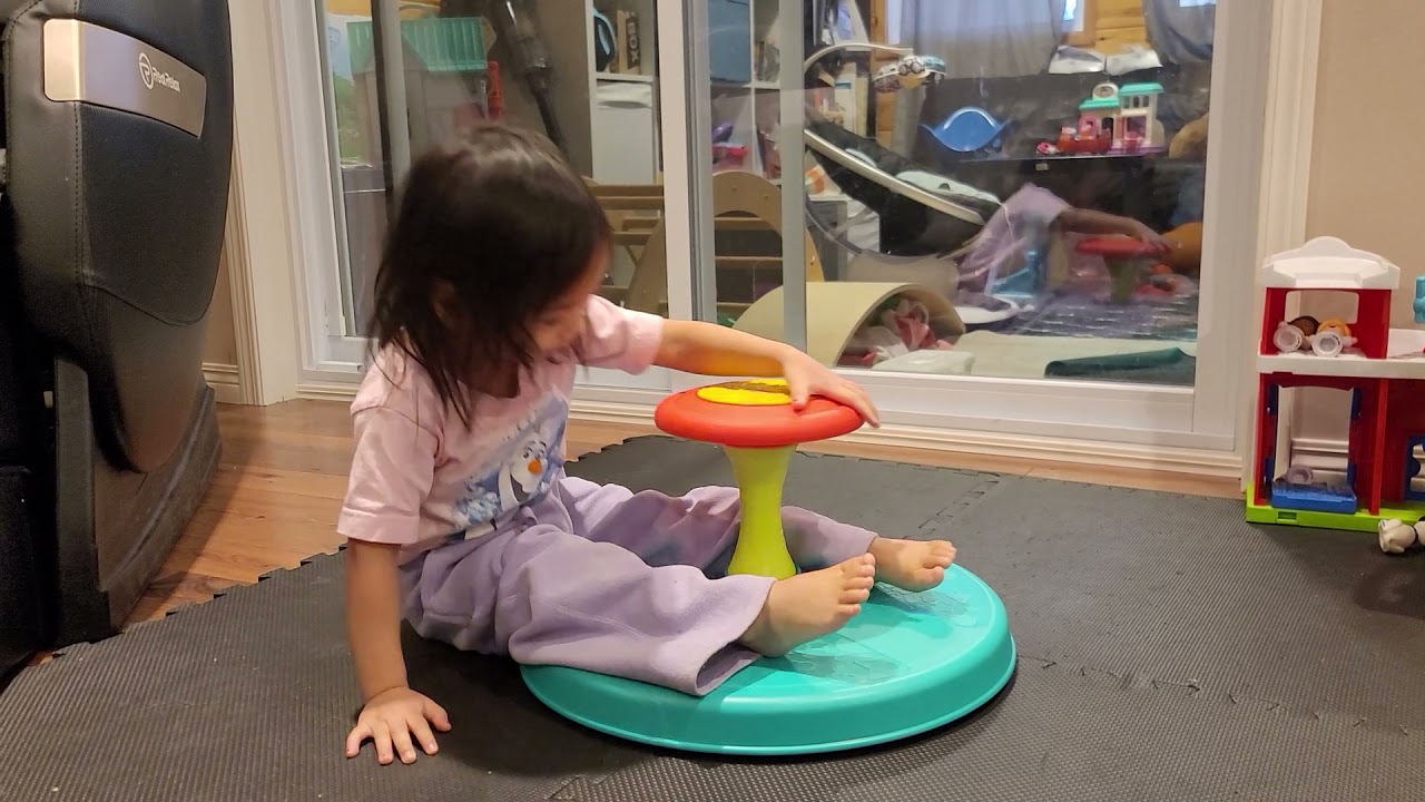 Toddler trying out the Playskool sit and spin