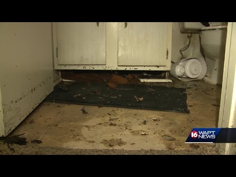 Camelot Apartment residents clean up after flooding