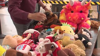 Volunteers hand out stuffed animals to kids at Mid-Ohio Food Bank
