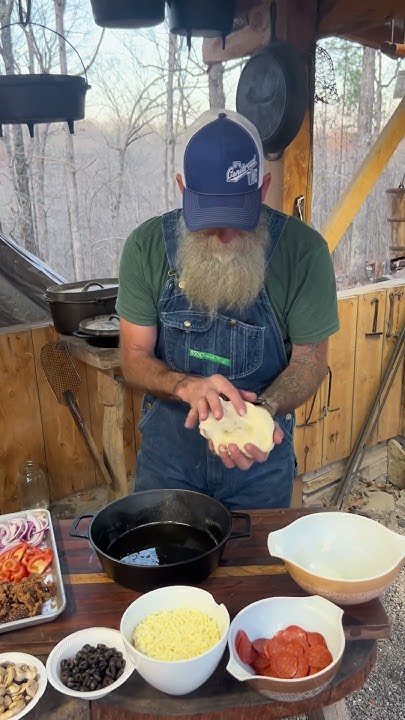 Homemade pizza over a open fire. #cooking #food #outdoorcooking #pizza