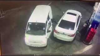 Thieves try to steal a man car while he is in a gas station pouring gas into his car