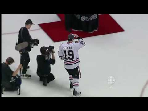 Jonathan Toews accepts the Stanley Cup and hans it...