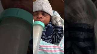 Tiny Newborn Baby Drinking His First Bottle Of Milk