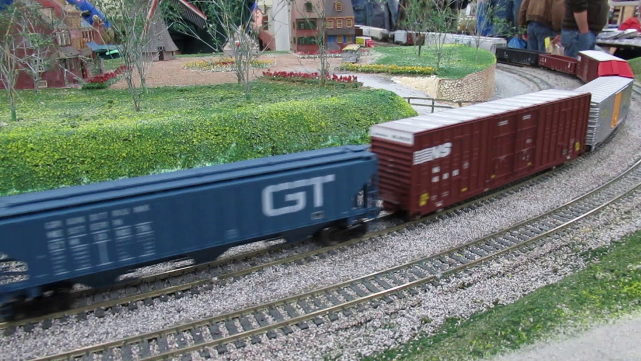 Norfolk Southern SD70M2s haul coil cars, gondolas, hoppers, box cars on HO scale model railroad