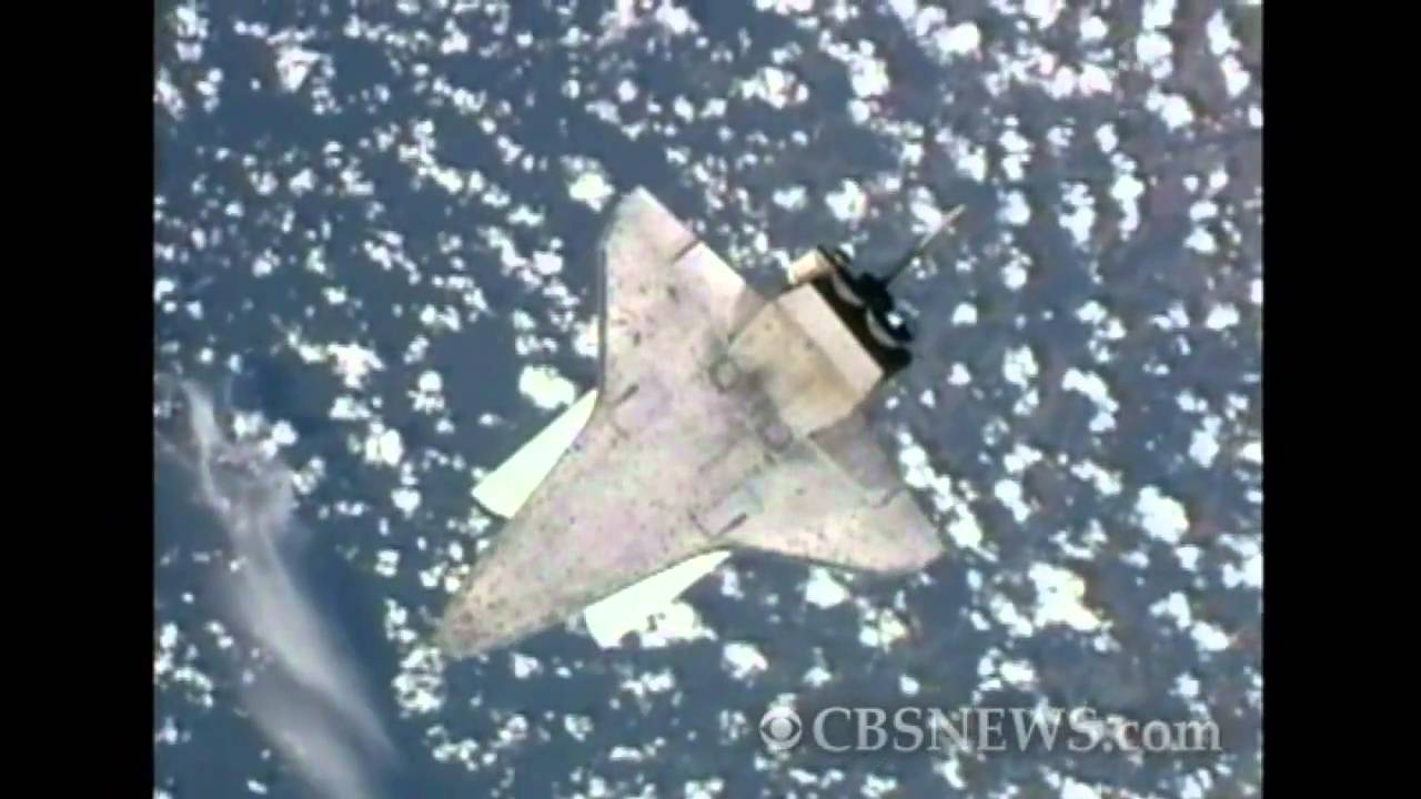 Space shuttle Discovery performs flip maneuver