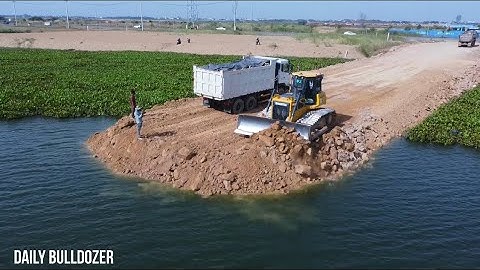 Skill Operator Shantui Dozer Pushing Rock And Soil Creating A new Long Road Across The Water