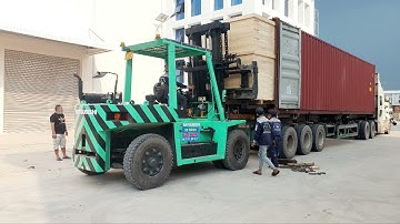 Unload machine from shipping container with forklift truck