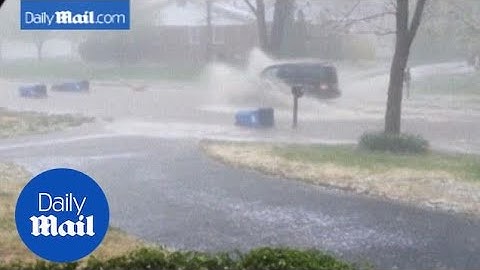 Trash cans float down flooded Missouri street in spring storm - Daily Mail