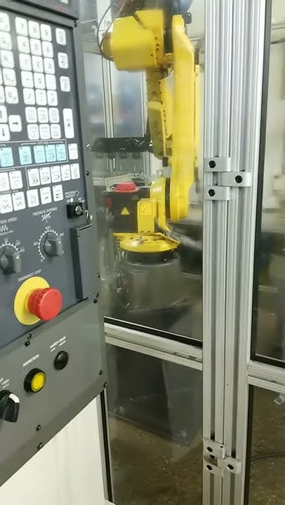 Robot loading and unloading parts into a Fanuc Robodrill - YouTube