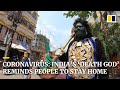 Indian man dresses as death god to remind people to stay home amid coronavirus pandemic