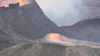 Lava flows out of a hole on the side of the crater of volcano Fagradalsfjall Iceland , 10 July 2021