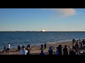 Spectators watch the final fiery moments of the Starship test flight