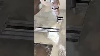 Waterjet cutter slices precise slots through sheet material underwater