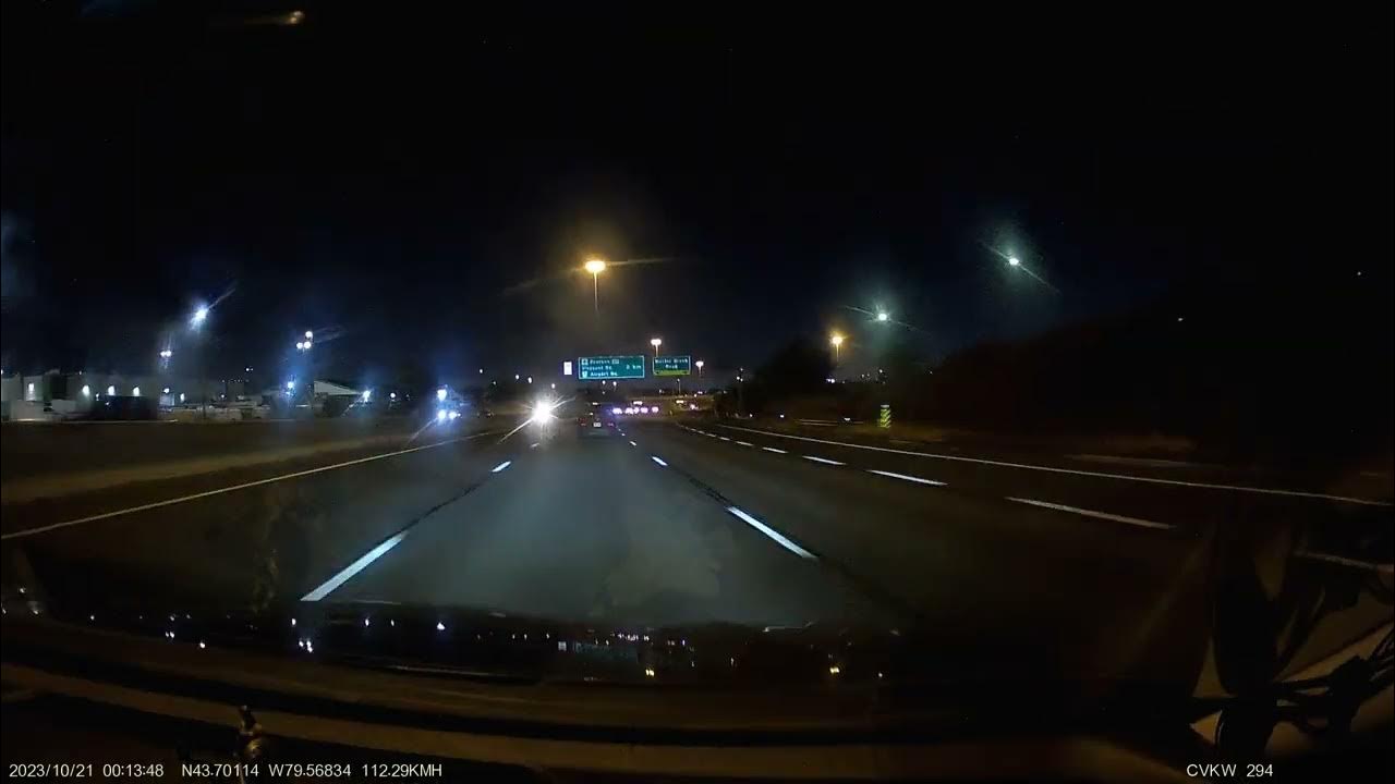 Vehicle with tail lights off drops orange material ahead in my path