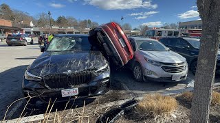Car wedged between vehicles after crash in grocery store parking lot