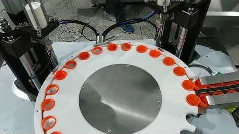 Rotary dual head caps wadding lining machine