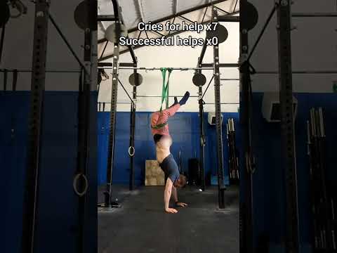 Guy's Pants Come Off as He Trains Upside Down With Resistance Band at Gym - 1418897