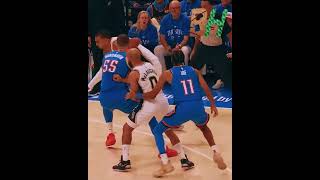 Wembanyama tips his own missed shot with his left hand on the other side of the rim.