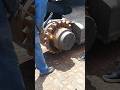 USING CUTTING TORCH TO MELT DOWN RUST PRIOR UNSCREW EXCAVATOR'S WHEEL SPROCKET IN MANUFACTURING SHOP