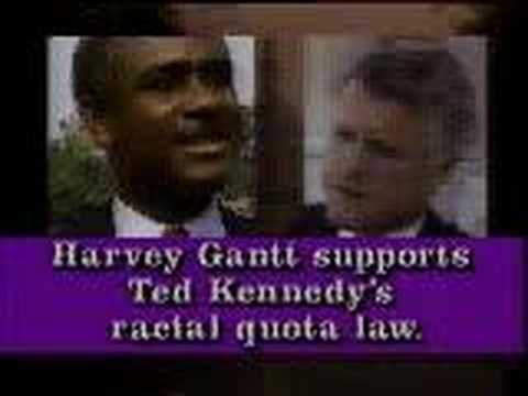 Jesse Helms' infamous thirty second commercial showing a pair of white hands crumpling a job rejection letter as a narrator says: "You needed that job, and you were the best qualified, but they had to give it to a minority, because of a racial quota. Is that really fair? Harvey Gantt says it is. Gantt supports Ted Kennedy's racial quota law that makes the color of your skin more important than your qualifications. Your vote on this issue next Tuesday. For racial quotas, Harvey Gantt. Against racial quotas, Jesse Helms."