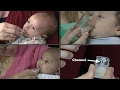 Cup feeding breast milk to an infant