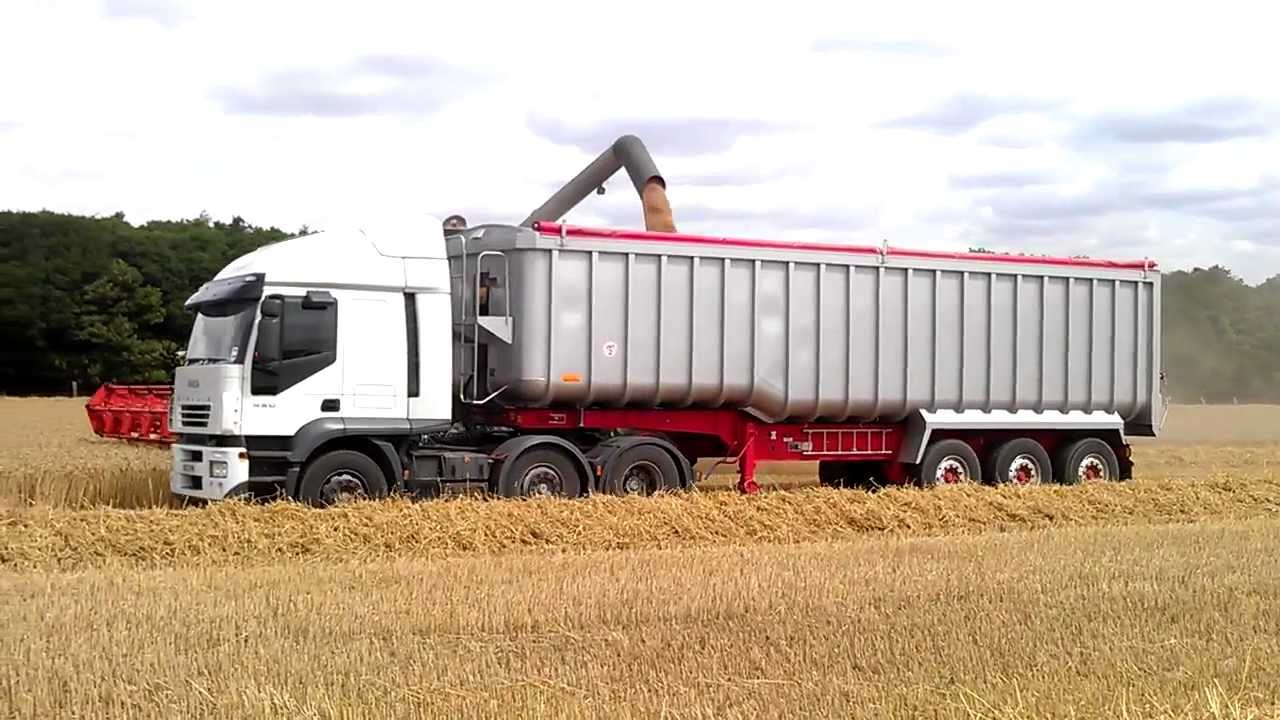 Lexion 600tt side filling lorrys on the move YouTube