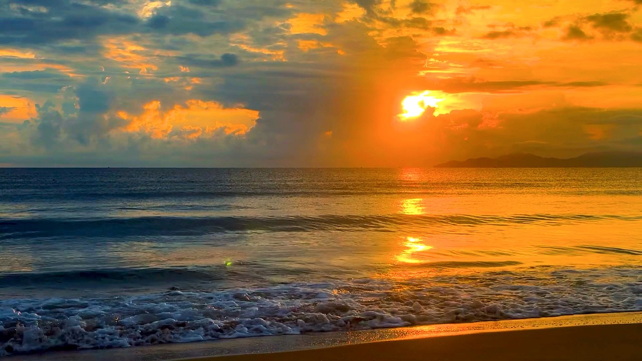 Golden Sunset Over Calm Ocean Waves on Peaceful Tropical Beach