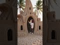 banana-house built entirely from sand, detailed sand architecture with realistic textures,