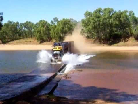 Road Train going flat-out over a river crossing - Western Australia