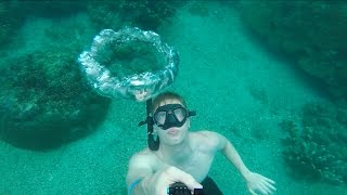 Freediver blowing bubble rings at Coral Garden, Amed Bali