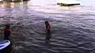 Kids practice waterskiing