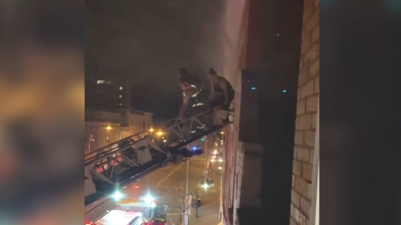 Caught on video: Firefighters rescue family from burning apartment ...