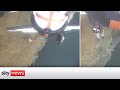 Watch moment helicopter rescues two people stranded on cliff edge