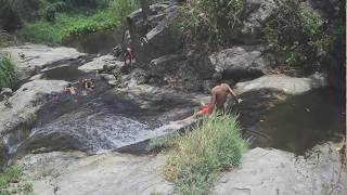 Monk children playing, sliding, jumping Bua Ban Wang waterfall Chiang Mai Thailand