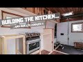 Building the kitchen units, our lpg cooker and rain delays.. building a van in the street in the UK!