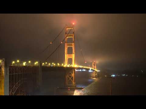 A night with Golden Gate in the cloudy sky.