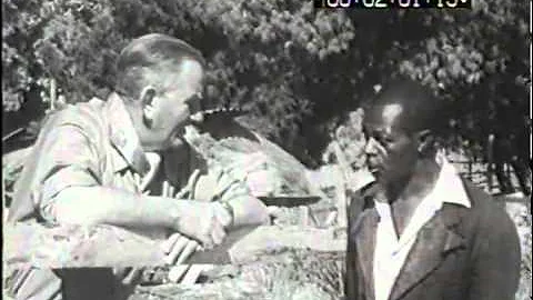 Hugh Tracey discussing the day's itinerary with hi...
