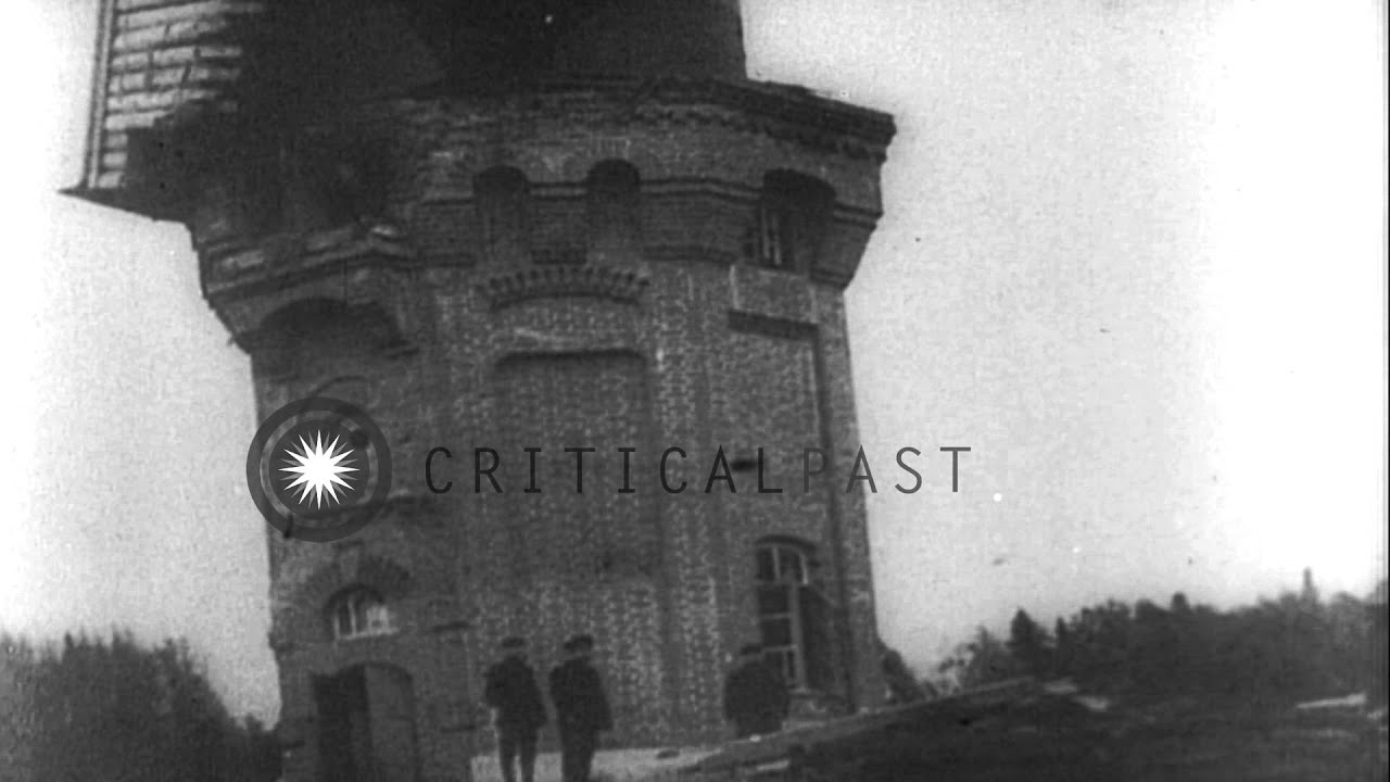 A railway bridge, damaged building and a wrecked vehicle in Russia during World W...HD Stock Footage