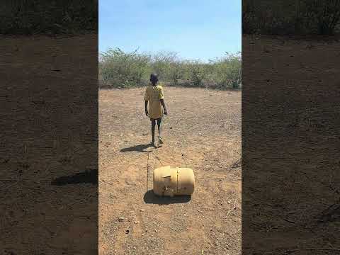 Turkana African village boy from fetching water from long distance.