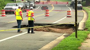 Large sinkhole swallows car; closes roads - CNN
