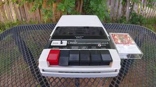 Africa by Toto playing on a broken slowed-down cassette player in the backyard