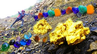 A gold hunter by a man has found many precious stones in the mountains under the rocks.