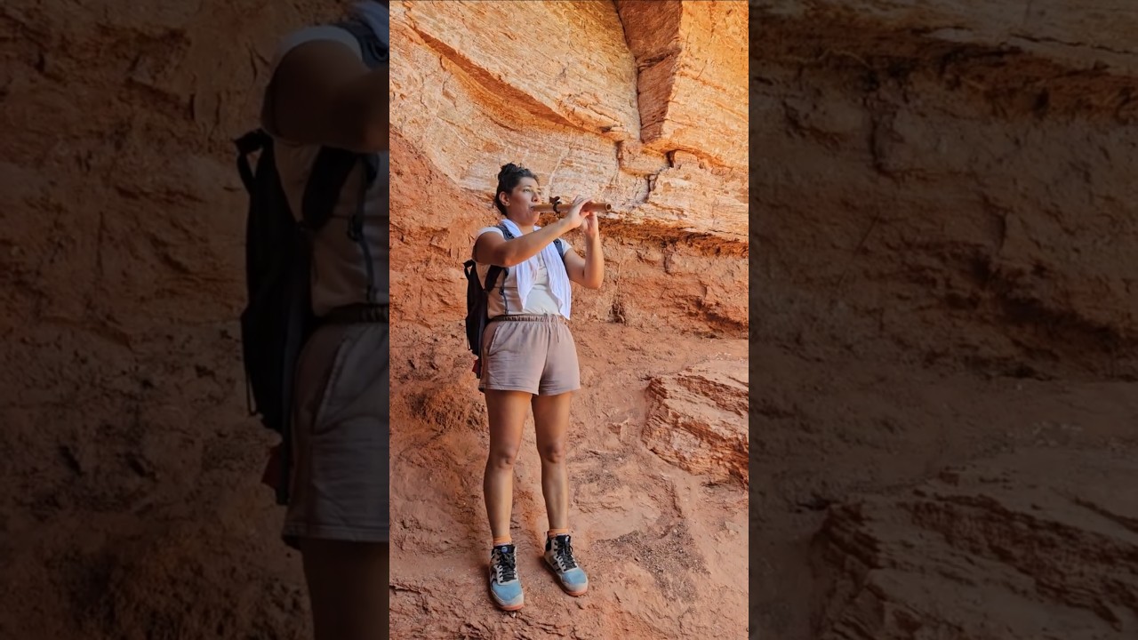 Breathtaking Native American Woman Plays Flute in Canyon