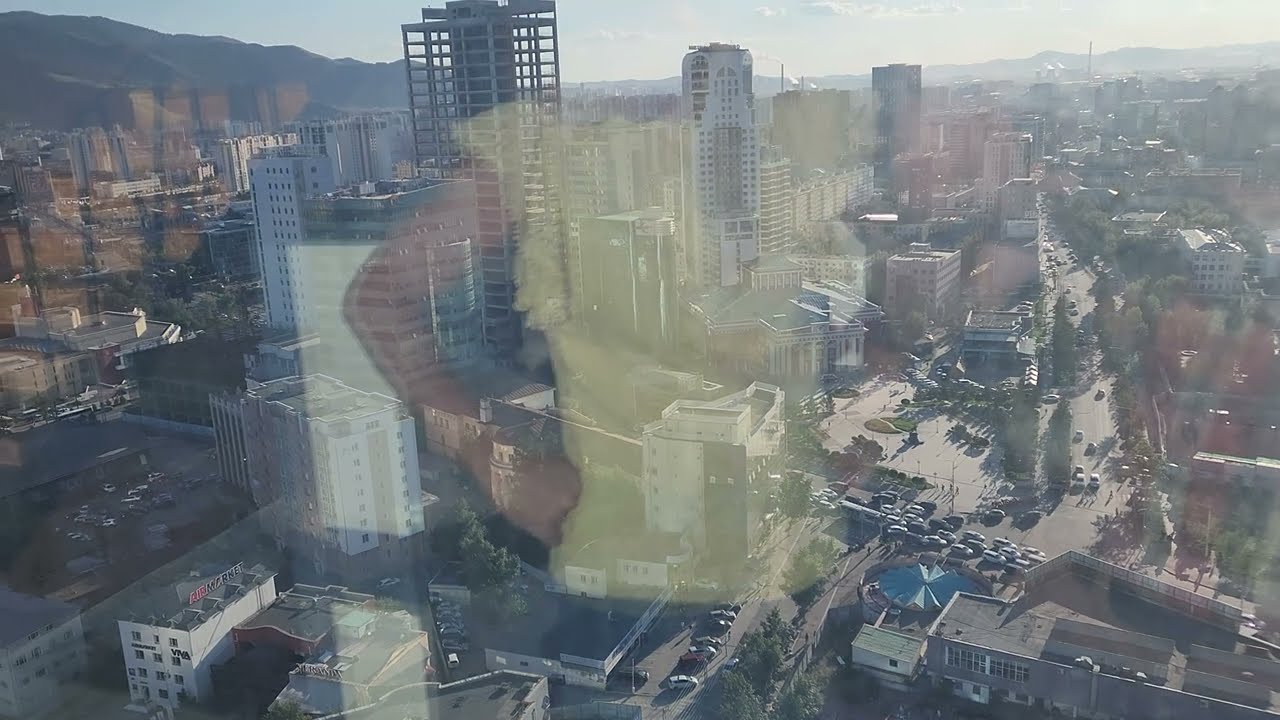 Riding the elevator up the blue sky hotel to the 23rd floor to see the city at sunset.